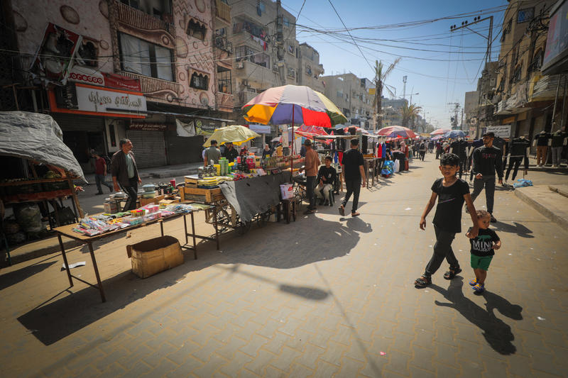 Palestinians shop at the market in the Nuseirat Refugee camp