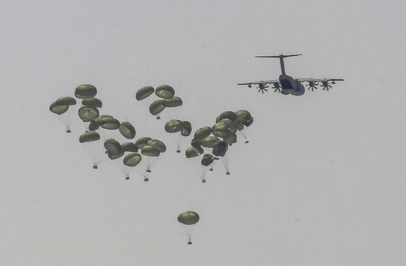 A plane drops humanitarian aid loaded with food supplies in the southern Gaza Strip