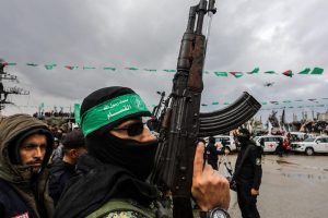 Members of the Al-Qassam Brigades hand over of Israeli hostages to the Red Cross, as part of the ceasefire agreement between Israel and Hamas, in Rafah, February 22, 2025.