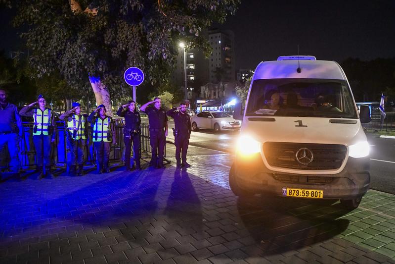 Israeli security forces pay their respects as the convoy carrying the bodies of hostages arrives at the Abu Kabir Forensic Institute in Tel Aviv, November 2, 2025.