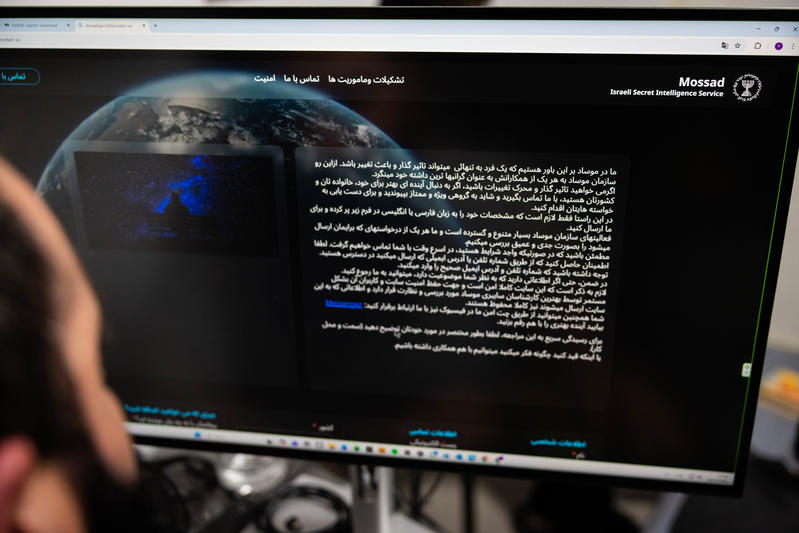 A man views a message published on the Mossad website, Israel’s secret intelligence service, on a computer screen, in Mishmar David, February 28. 2026.