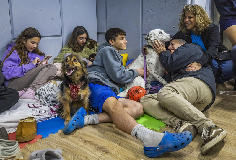Israelis take cover at a public shelter in Mazkeret Batya as a siren sounds warning of incoming ballistic missiles fired from Iran toward Israel, March 8, 2026.