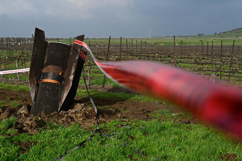A fragment of a missile fired from Iran toward Israel, intercepted by Israeli air defence systems, seen lodged in the ground in the Golan Heights, March 19, 2026.