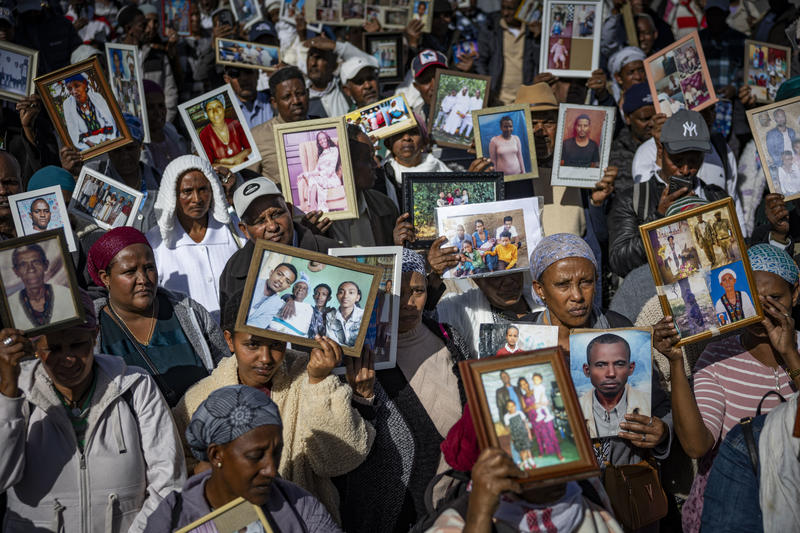 Members of the Jewish Ethiopian community hold up family photos of loved ones who remain in Ethiopia, during a protest demanding the government to bring the rest of the Falashmura, near the Knesset, in Jerusalem, on February 1, 2026.