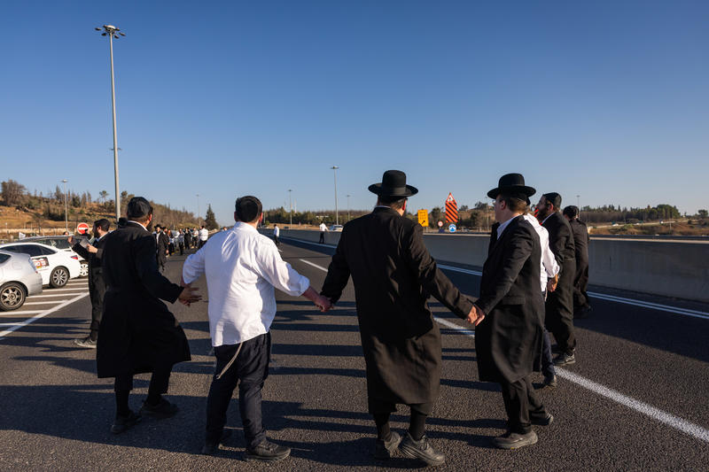 Ultra-Orthodox Jewish men block Highway 1 toward Tel Aviv during a protest against the imprisonment of yeshiva students who failed to comply with military recruitment orders, near Jerusalem, June 24, 2026.