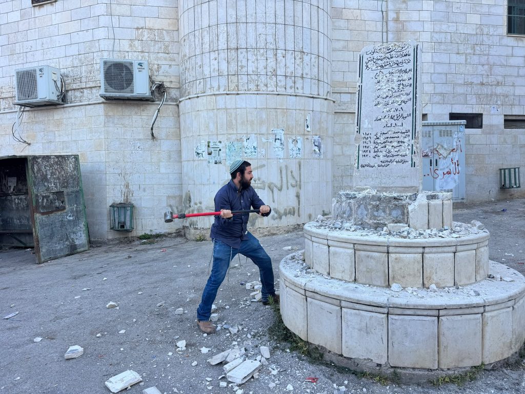 Tzvi Sukkot, MK from the Religious Zionism Party led by Bezalel Smotrich, taking a sledgehammer to a monument erected in Madama to commemorate “martyrs” in the Palestinian fight against Israel, August 25, 2026.